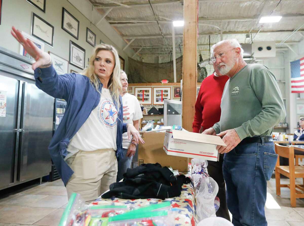 Cara Johnson with the Spring Creek Blue Star Mothers explains to Jim Krepper the process of packing one of 100 gift boxes for military service men and women at Honor Cafe, Saturday, March 19, 2022, in Conroe. The cafe will be featured on "The Texas Bucket List" show Nov. 12. 