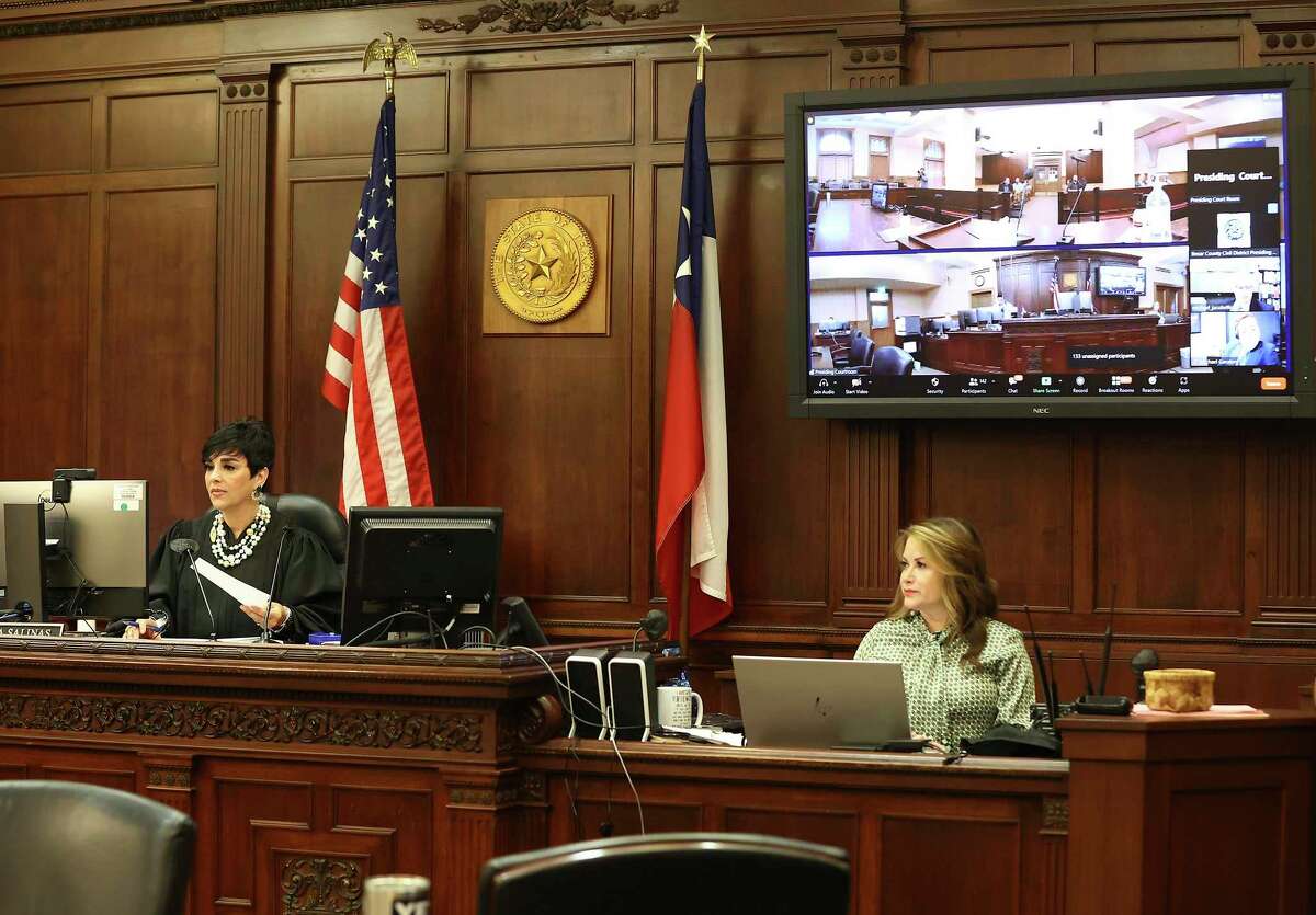 State District Judge Laura Salina, at left, assigns civil cases to other judges Thursday for proceedings that are once again being held in person — but her docket, evidence submission and jury selection are still partly done with videoconferencing.
