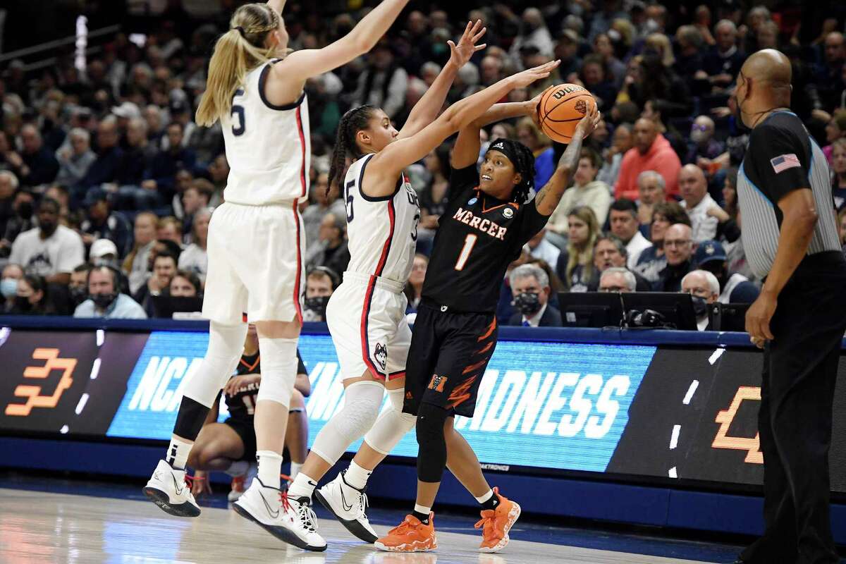 UConn’s Paige Bueckers, left, and Azzi Fudd, center, pressure Mercer’s Amoria Neal-Tysor during the first half Saturday in Storrs.