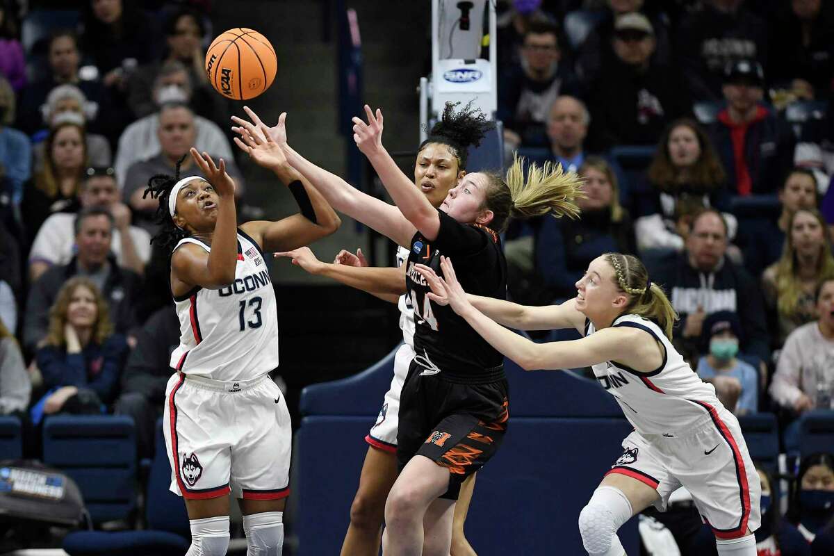 From left, UConn’s Christyn Williams, Olivia Nelson-Ododa and Paige Bueckers reach for a rebound against Mercer’s Allie Thayne, center, during their NCAA Tournament first-round game Saturday in Storrs.