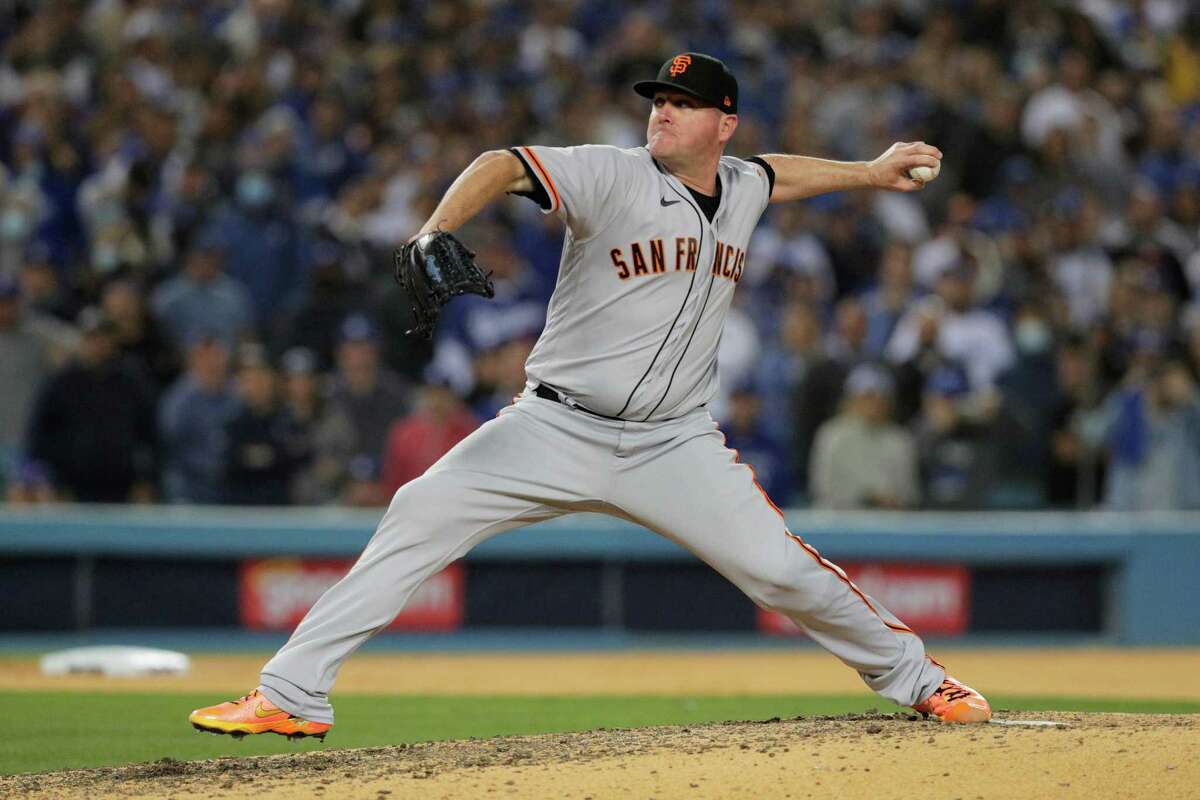San Francisco Giants relief pitcher Jake McGee (17) throws during the seventh inning as the San Francisco Giants played the Los Angeles Dodgers in Game 3 of the National League Division Series at Dodger Stadium in Los Angeles, Calif. on Monday, Oct. 11, 2021.