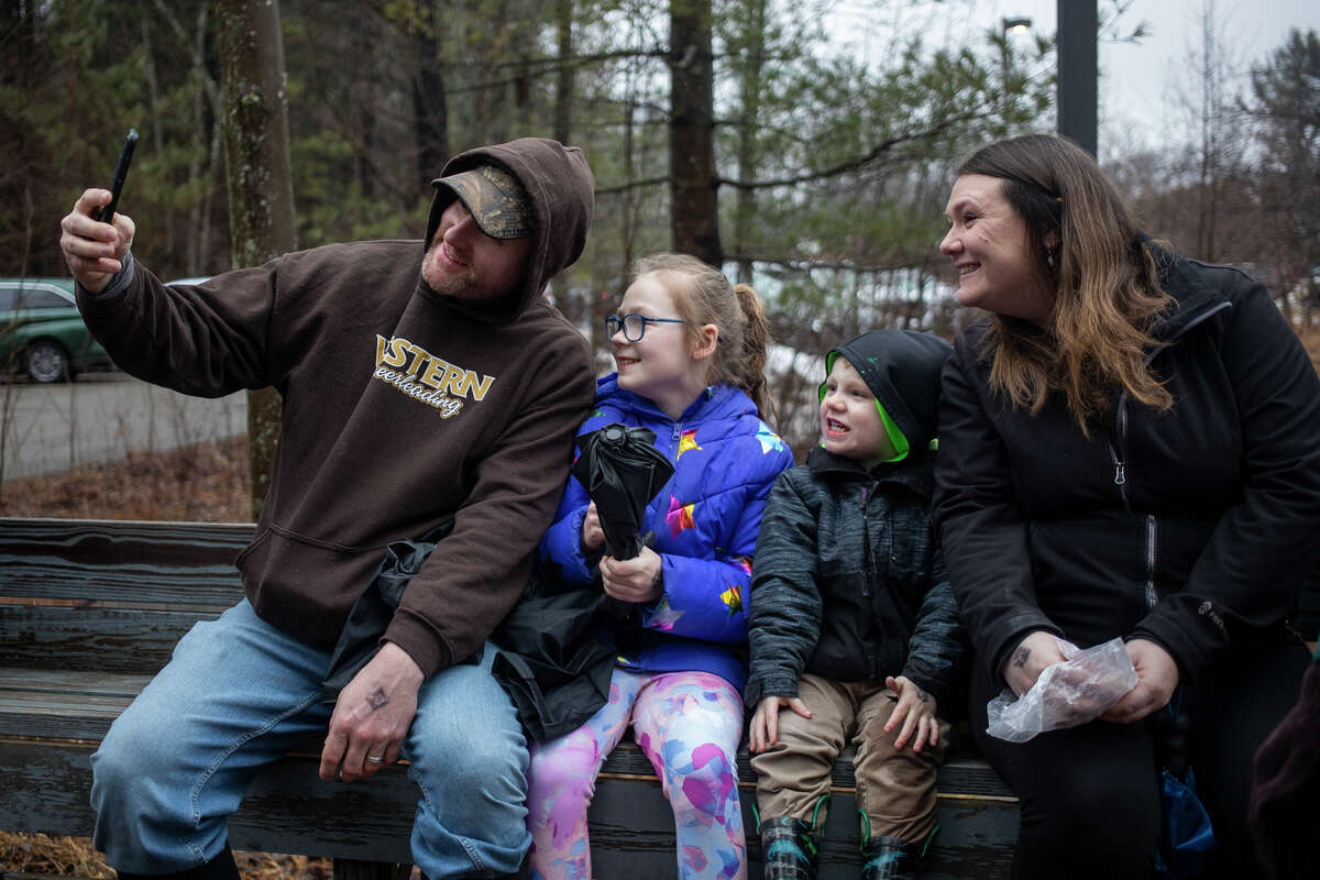 From left, Tim Green, Adi Green, 8, Jon Green, 3, and Nicole Green take a selfie together while riding a tractor-drawn wagon during the annual Maple Syrup Day event Saturday, March 19, 2022 at Chippewa Nature Center.