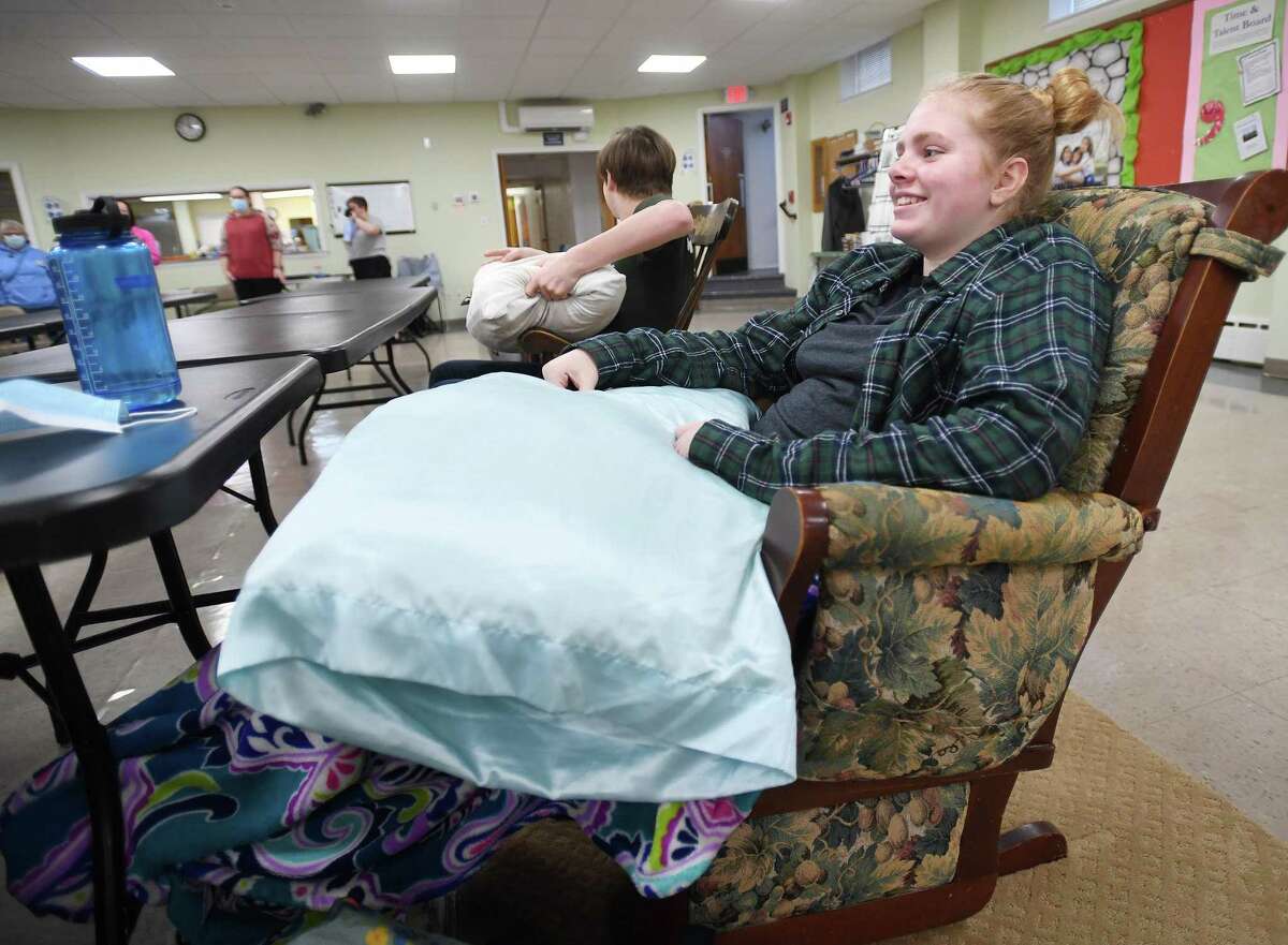 Sadie Grant-Eckhart, 12, of Milford, and other members of the Junior Pilgrim Fellowship middle school youth group, participate in the annual 24 hour rocking chair fundraiser at First United Church of Christ in Milford, Conn., on Saturday, March 19, 2022. The fundraiser, this year benefitting The Trevor Project, a suicide prevention project for LGBTQ youth, goes back over 45 years.