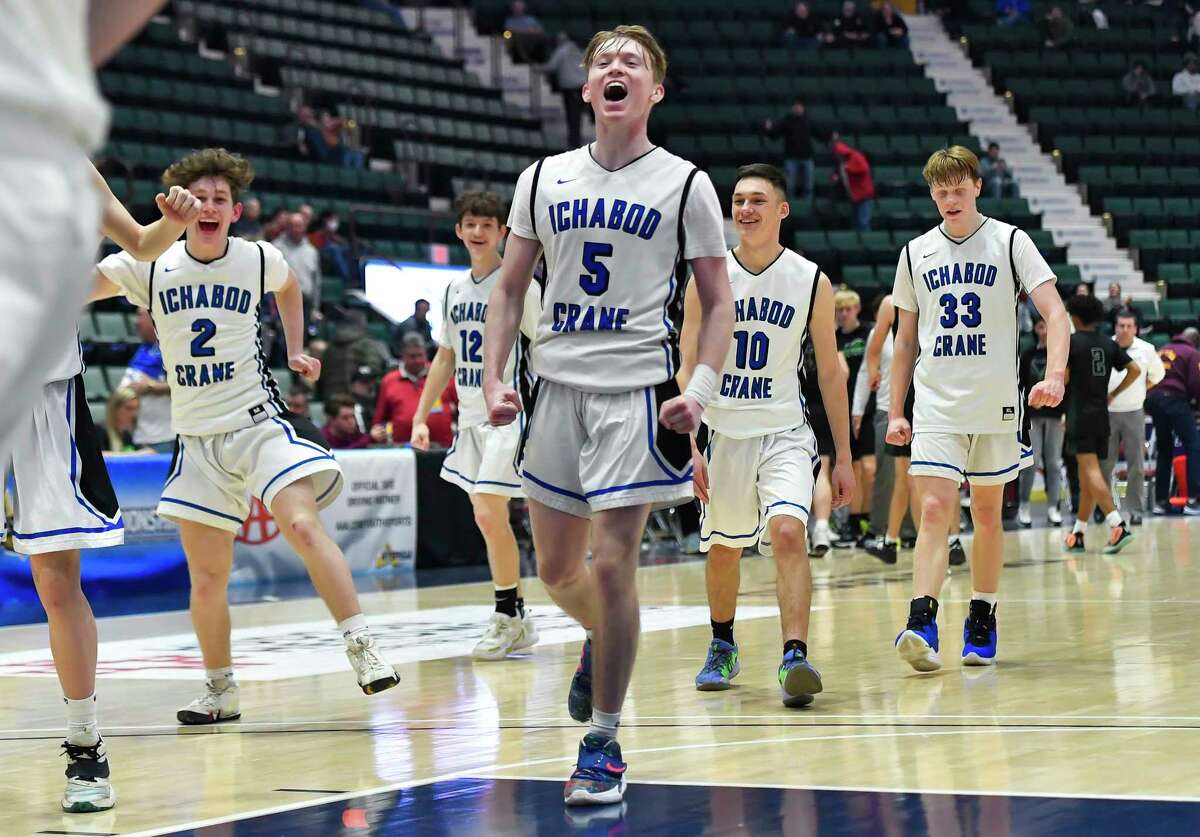 Ichabod Crane's Alex Schmidt (5) and his teammates Quinn Rapport (2), Jack Mullins (12), Avery Clickman (10) and Daniel Warner (33) celebrate their win over Allegany-Limestone in a Class B semifinal at the NYSPHSAA Boys Basketball Championships in Glens Falls, N.Y., Saturday, March 19, 2022. (Adrian Kraus / Special to the Times Union)
