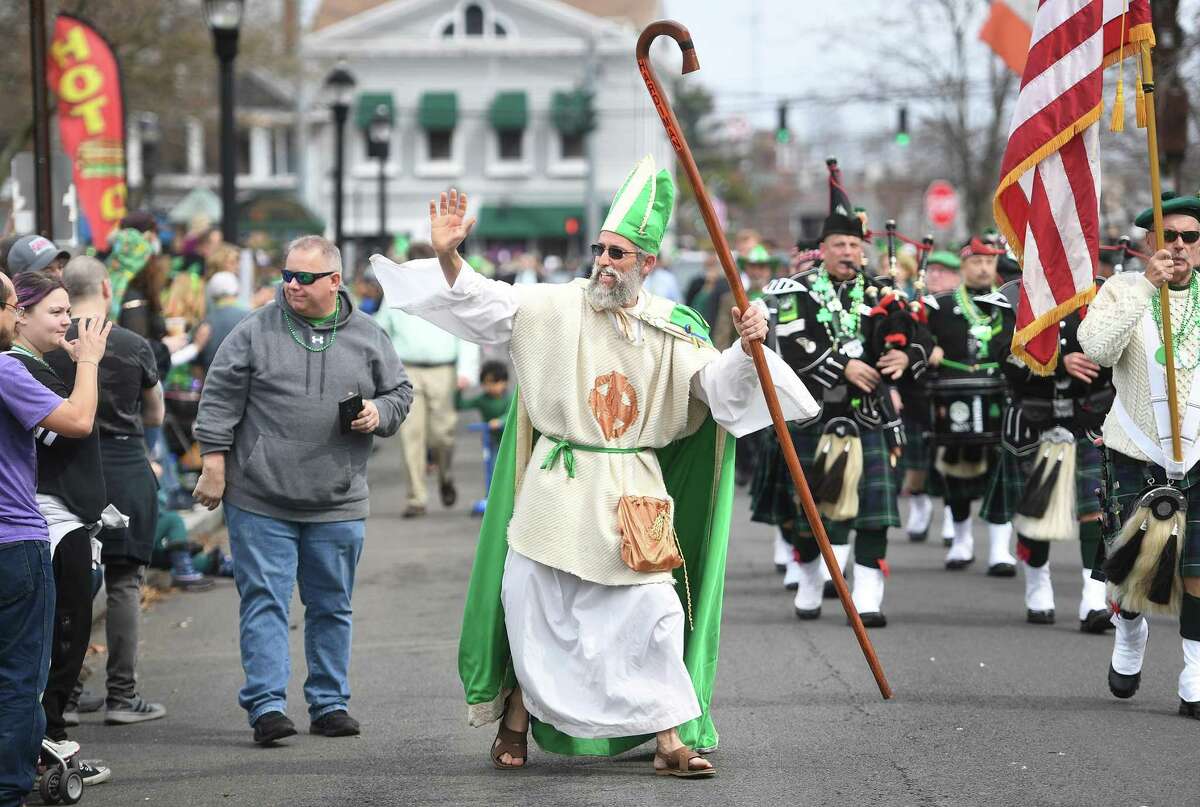 Saint Patrick, aka Peter Ortoleva, of Milford, marchers in the annual St. Patrick's Day Parade on Broad Street in Milford, Conn., on Saturday, March 19, 2022. Ortoleva has been portraying the saint in both Milford and New Haven parades since 1996.