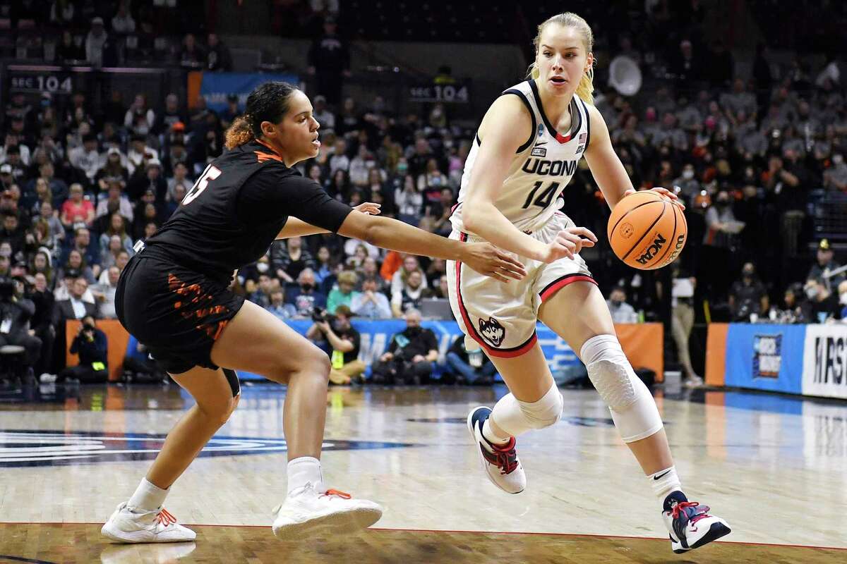Connecticut's Dorka Juhasz, right, dribbles around Mercer's Nigeria Harkless, left, during the second half of a first-round women's college basketball game in the NCAA tournament, Saturday, March 19, 2022, in Storrs, Conn. (AP Photo/Jessica Hill)