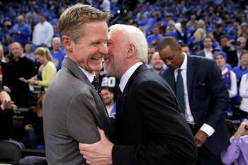 Warriors head coach Steve Kerr shares a moment with Gregg Popovich before the first half of the Golden State Warriors game against the San Antonio Spurs at Oracle Arena in Oakland, Calif., on Monday, January 25, 2016.