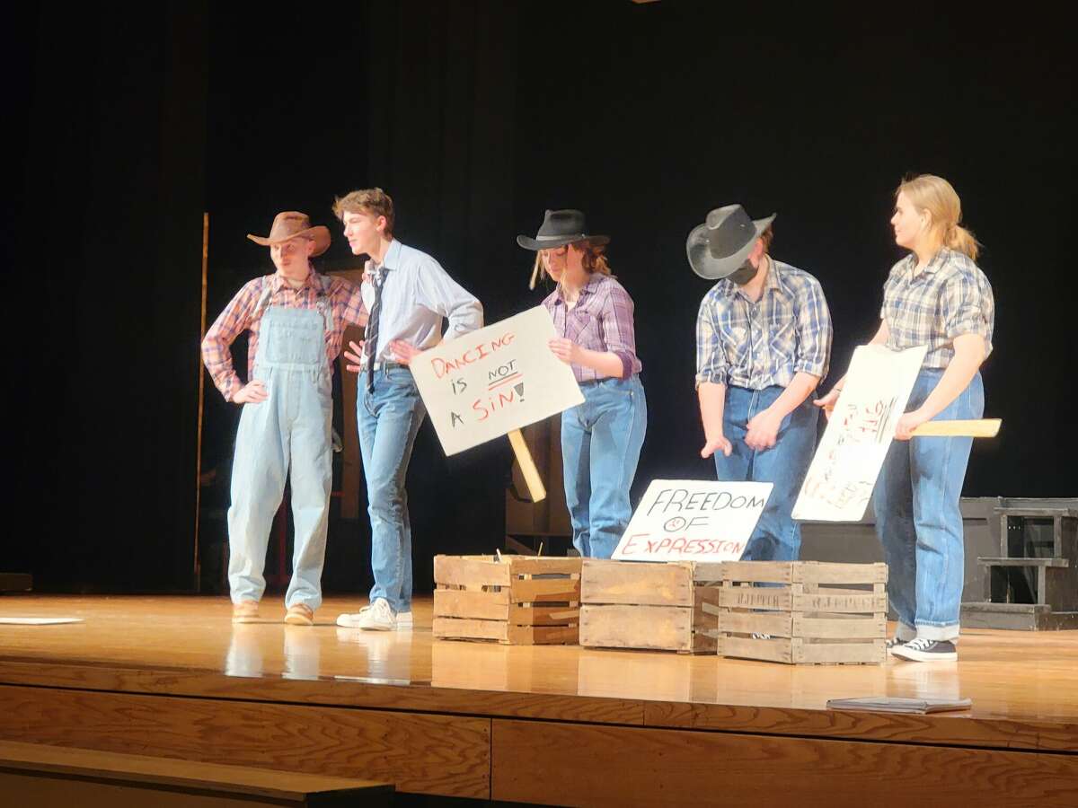 Ren McCormack, Cowboy Bob and others protest the ban on dancing in Footloose: The Musical. 