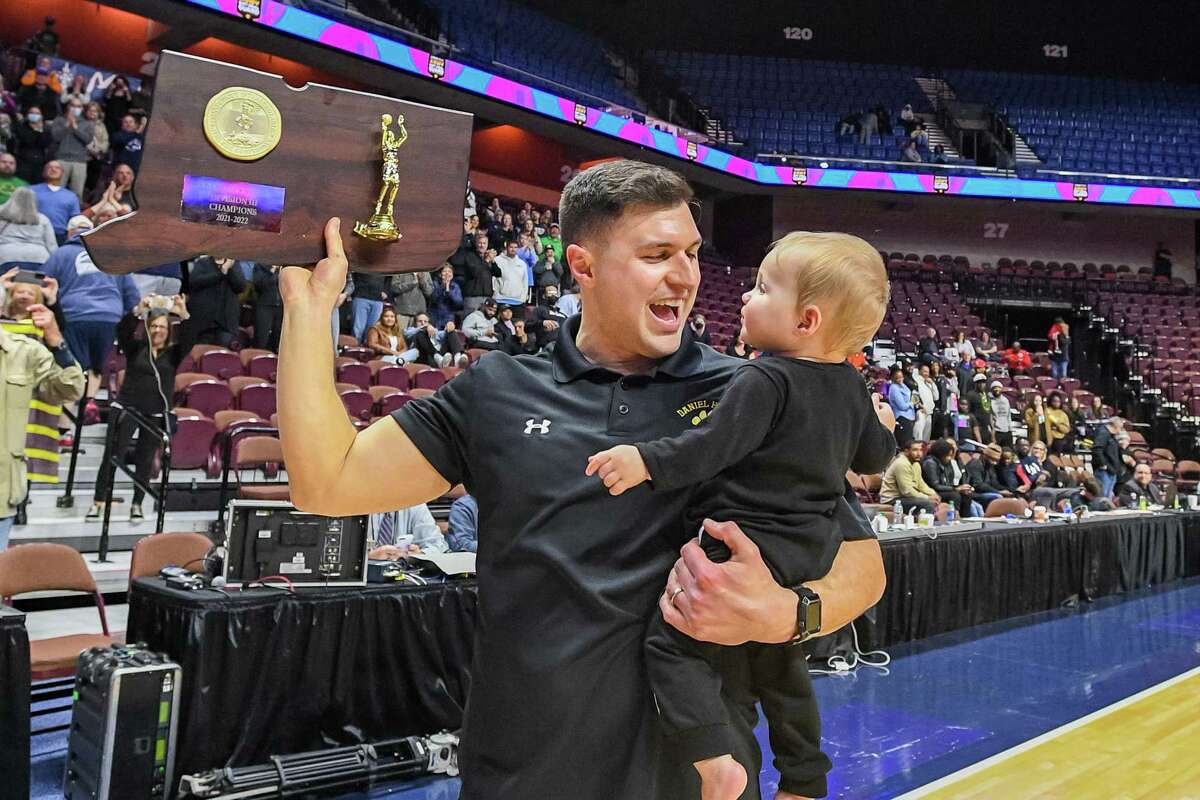 Daniel Hand Head Coach Jimmy Economopoulos celebrates after the Tigers won the CIAC Division III boys final against Kolbe Cathedral at Mohegan Sun Arena, Saturday, March 19, 2022.
