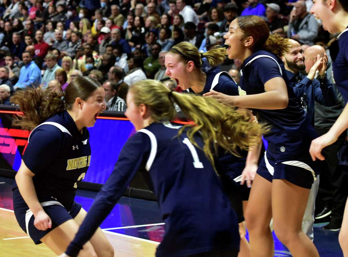 Notre Dame of Fairfield celebrates its win over Newington in Girls basketball Class L state championship action at Mohegan Sun Arena in Uncasville, Conn., on Saturday March 19, 2022.