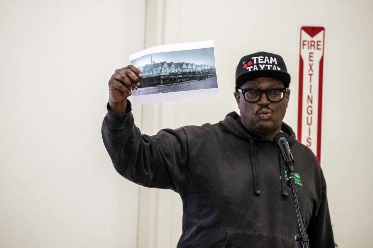 David Peters, a third-generation Oakland resident, holds a photograph of Seventh Street from the 1940s during a community meeting on the Oakland A’s ballpark proposal at Taylor Memorial Church in Oakland on Saturday.