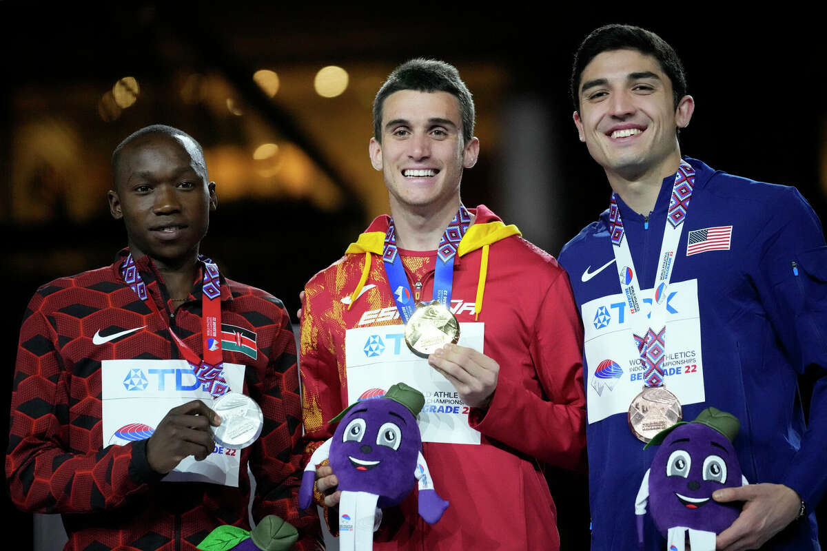 Silver medalist Noah Kibet, of Kenya, gold medalist Mariano Garcia, of Spain, and bronze medalist Bryce Hoppel, of the United States, from left, pose with their medals on the podium of the Men's 800 meters at the World Athletics Indoor Championships in Belgrade, Serbia, Saturday, March 19, 2022. (AP Photo/Darko Vojinovic)