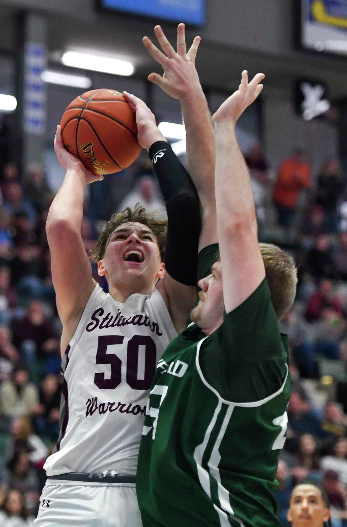 Stillwater's Jaxon Mueller (50) takes a shot over Newfield's Garrett Porter during the Class C final at the NYSPHSAA Boys Basketball Championships in Glens Falls, N.Y., Saturday, March 19, 2022. (Adrian Kraus / Special to the Times Union)