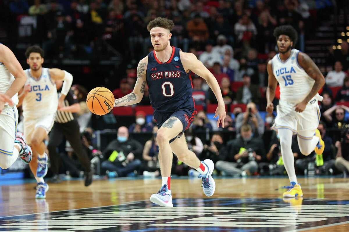 PORTLAND, OREGON - MARCH 19: Logan Johnson #0 of the St. Mary's Gaels dribbles the ball down court during the first half against the UCLA Bruins in the second round of the 2022 NCAA Men's Basketball Tournament at Moda Center on March 19, 2022 in Portland, Oregon. (Photo by Abbie Parr/Getty Images)