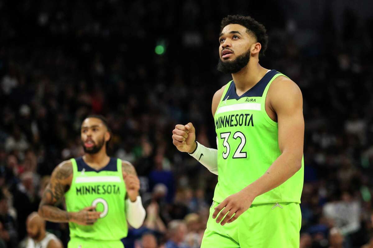 MINNEAPOLIS, MN - MARCH 19: Karl-Anthony Towns #32 celebrates recording an assist on a basket made by D'Angelo Russell #0 of the Minnesota Timberwolves against the Milwaukee Bucks in the fourth quarter of the game at Target Center on March 19, 2022 in Minneapolis, Minnesota. The Timberwolves defeated the Bucks 138-119. NOTE TO USER: User expressly acknowledges and agrees that, by downloading and or using this Photograph, user is consenting to the terms and conditions of the Getty Images License Agreement. (Photo by David Berding/Getty Images)
