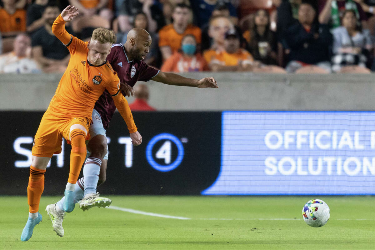 Houston Dynamo forward Tyler Pasher (19) collides with Colorado Rapids midfielder Collen Warner (32) in the second half at PNC Stadium on March 19, 2022 in Houston. Houston Dynamo tied the Colorado Rapids 1 to 1.