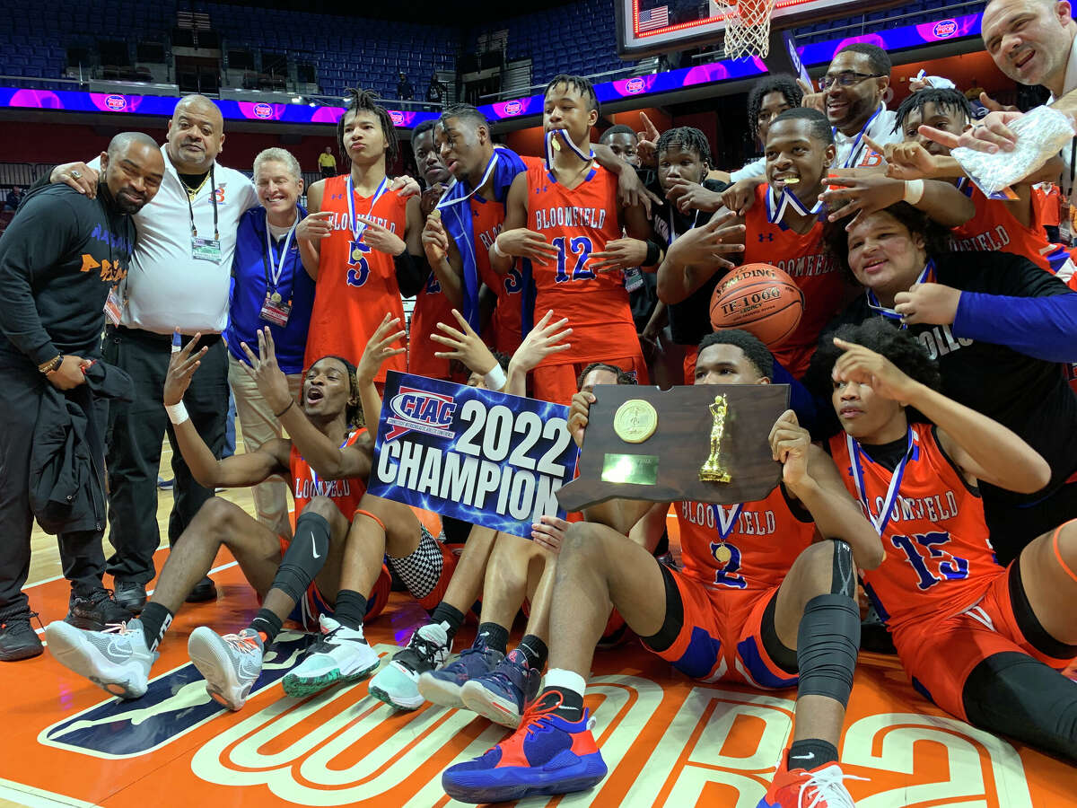 Bloomfield's boys basketball team celebrates its 58-54 Division IV championship victory over Granby Memorial, Sunday, March 20, 2022 at Mohegan Sun Arena.