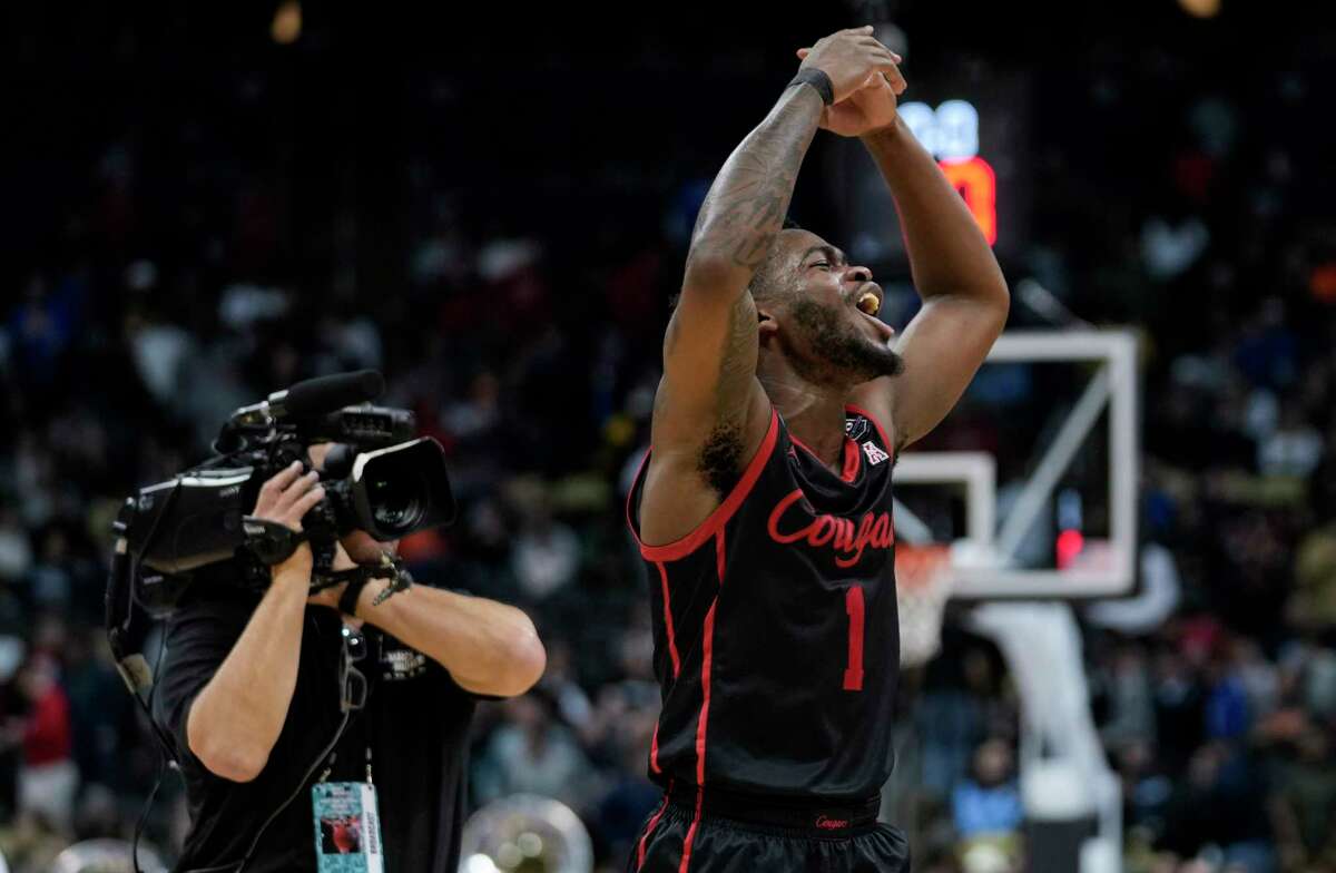 Houston guard Jamal Shead (1) celebrates after the Cougars beat Illinois 68-53 in a second-round game in the NCAA men’s college basketball tournament dow}, March 20, 2022 in Pittsburgh. The Cougars advanced to the Sweet 16 of the tournament with the win.