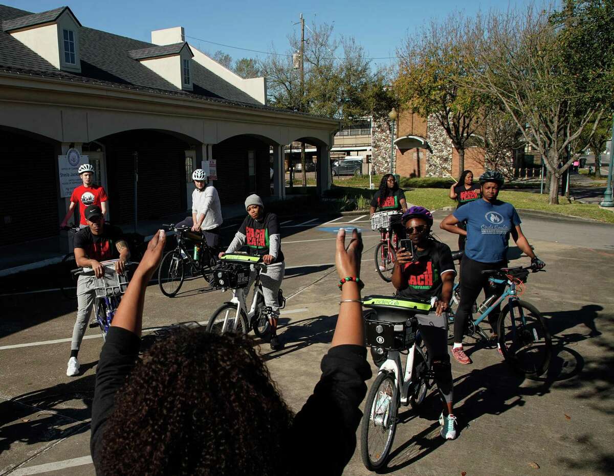 Our Afrikan Family’s Kendra London, foreground, talks to riders during the "Storytime Bike Line" tour, a bike tour of Fifth Ward to teach residents and non-residents about the rich history of one of Houston's oldest Black neighborhoods, on Saturday, March 19, 2022, in Houston.