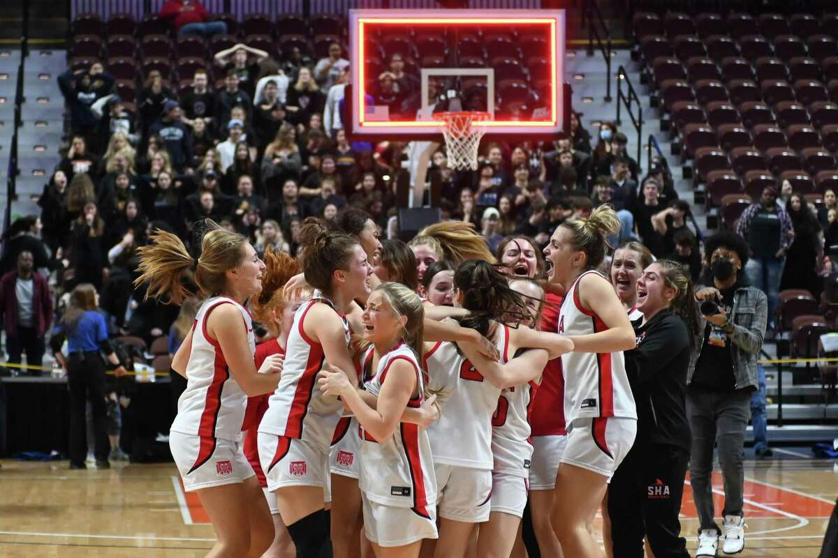 Sacred Heart Academy players celebrate winning the CIAC Class MM girls basketball championship on Sunday at Mohegan Sun Arena.