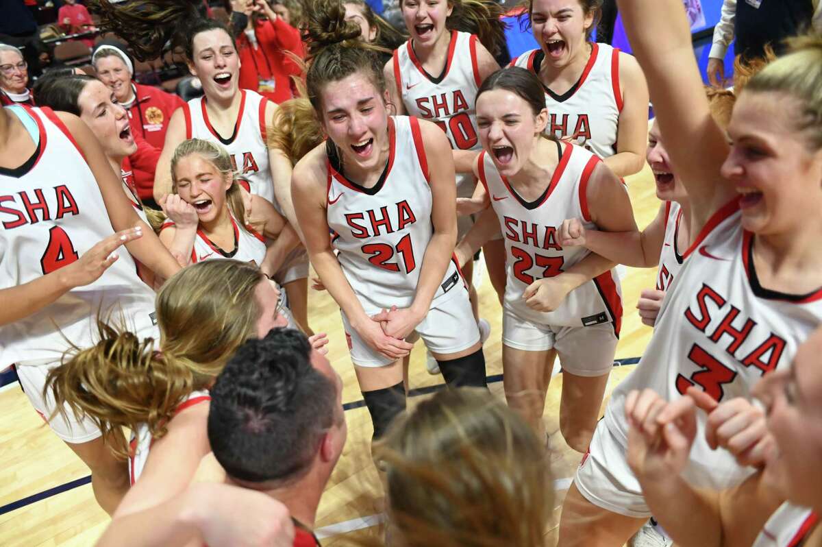 Sacred Heart Academy players celebrate winning the CIAC Class MM championship Sunday at Mohegan Sun Arena in Uncasville.
