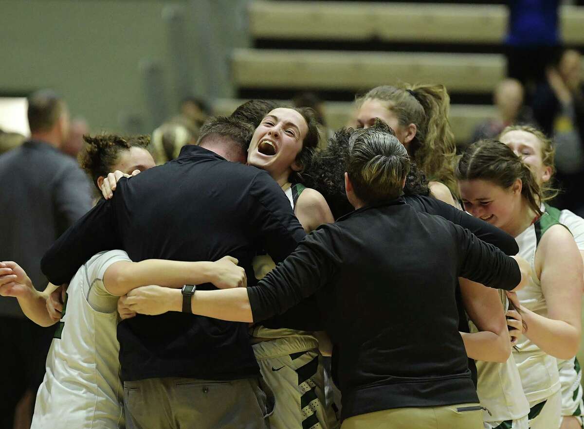Payton Graber of Schalmont hugs Schalmont head coach Jeff VanHoesen after the team beat Waterloo in their New York State Public High School Athletic Association girls' Class B championship game on Sunday, March 20, 2022, in Troy, N.Y. (Paul Buckowski/Times Union)