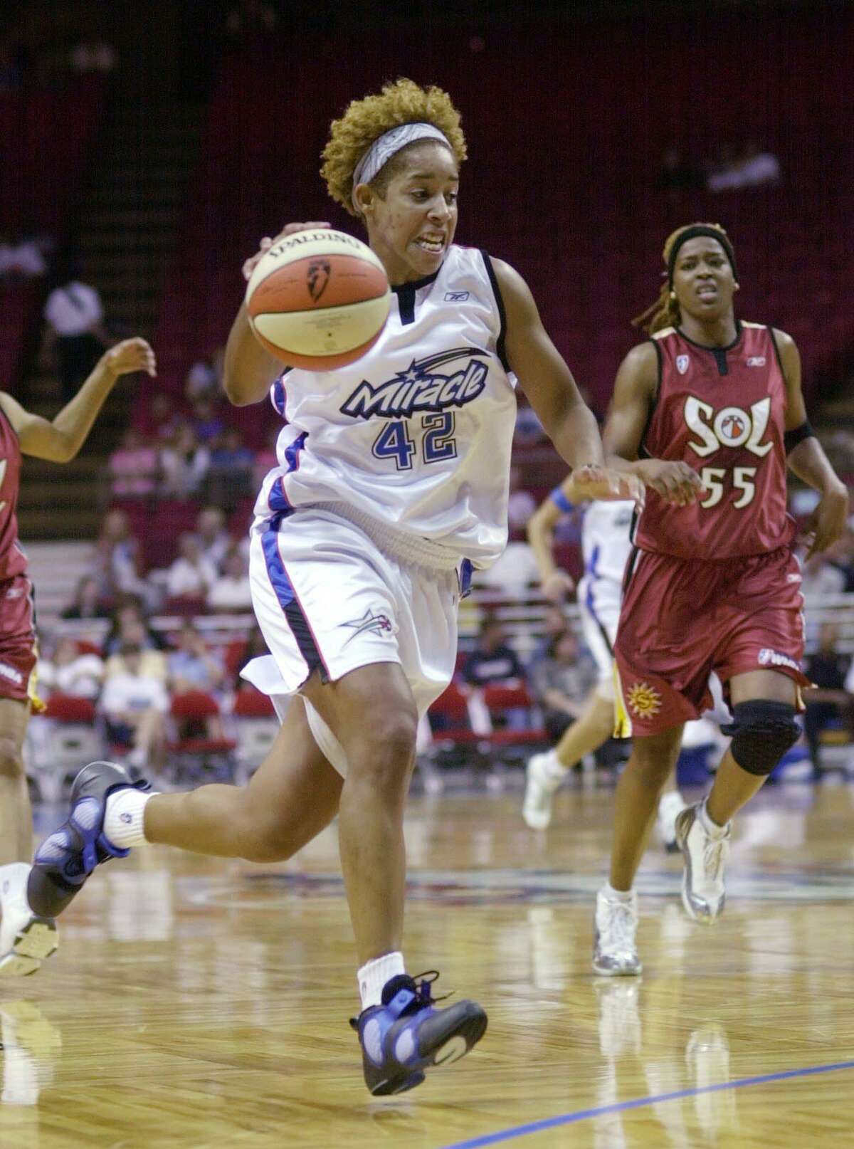 The Orlando Miracle's Nykesha Sales drives to the basket during a 2002 WNBA game.