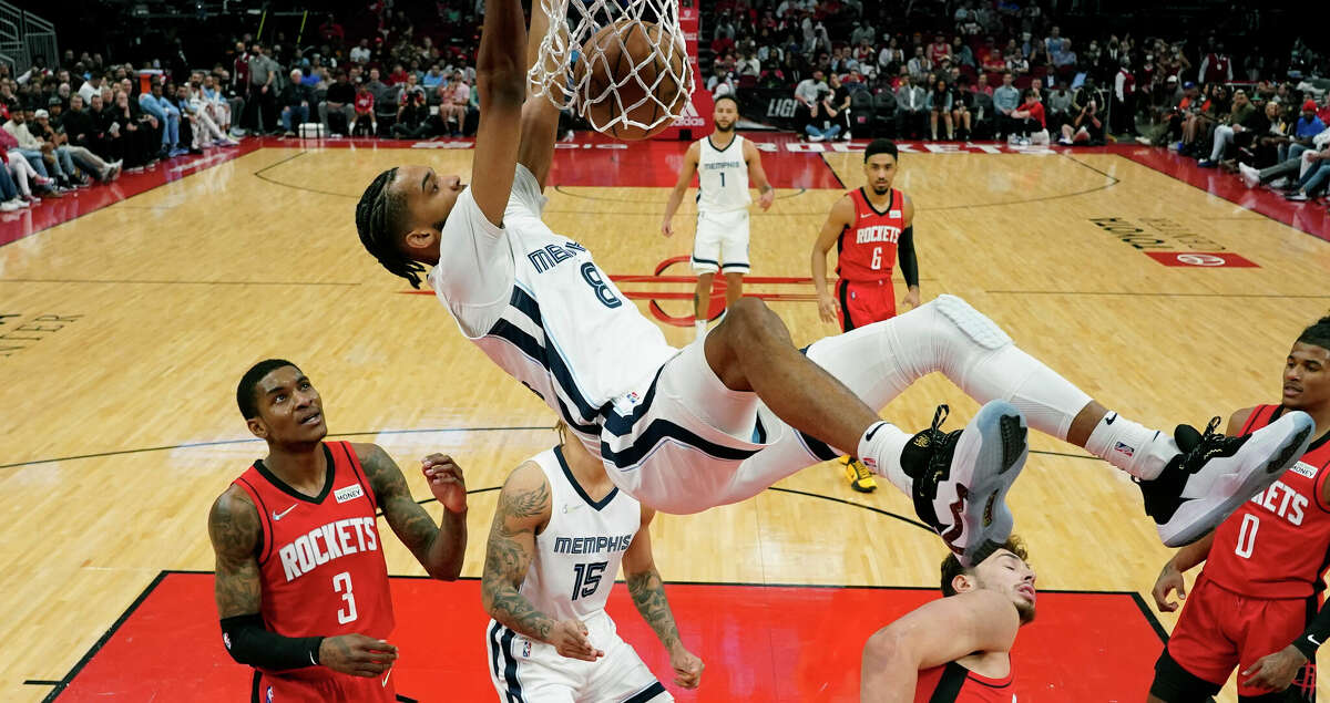 Memphis Grizzlies guard Ziaire Williams (8) dunks during the first half of an NBA basketball game against the Houston Rockets, Sunday, March 20, 2022, in Houston. (AP Photo/Eric Christian Smith)