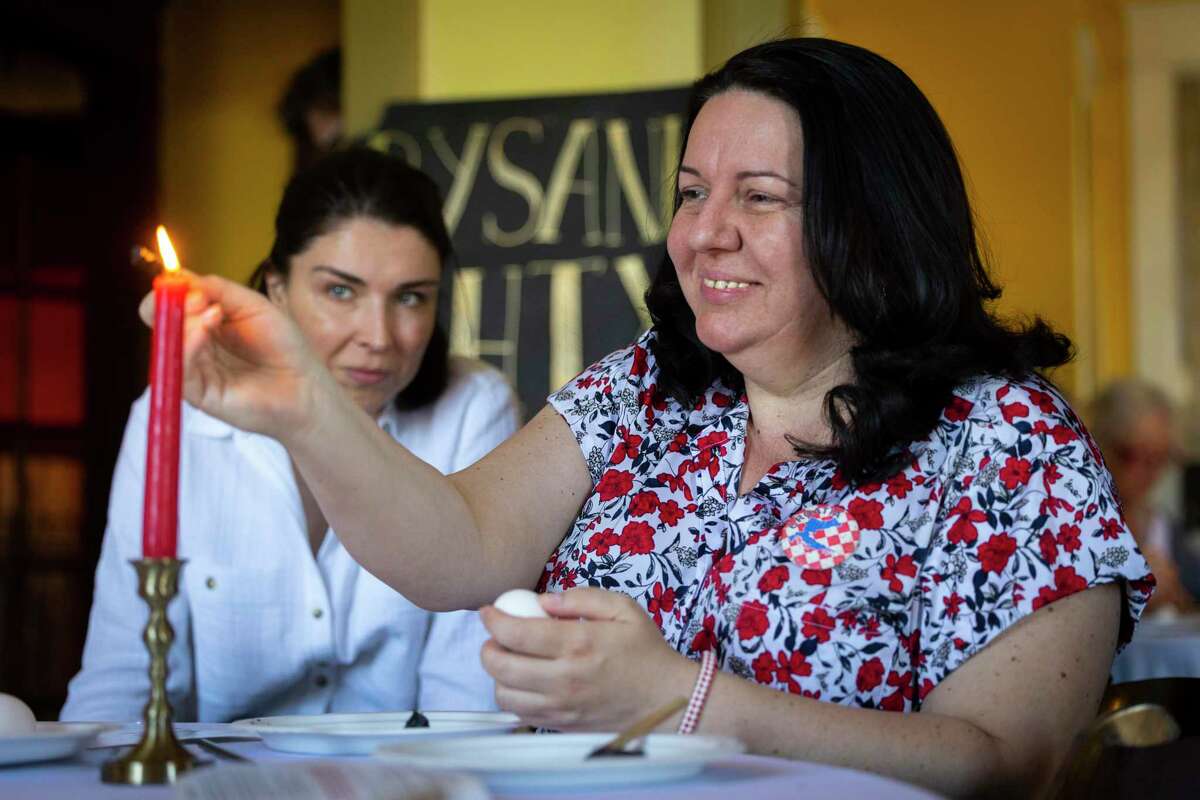 Danijela Miškic decorates an egg during a free workshop on the art of creating Ukrainian pysanky at AvantGarden on Sunday.