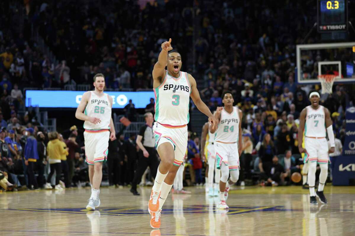 San Antonio Spurs forward Keldon Johnson (3) celebrates after making the winning basket against the Golden State Warriors during the second half of an NBA basketball game in San Francisco, Sunday, March 20, 2022. (AP Photo/Jed Jacobsohn)