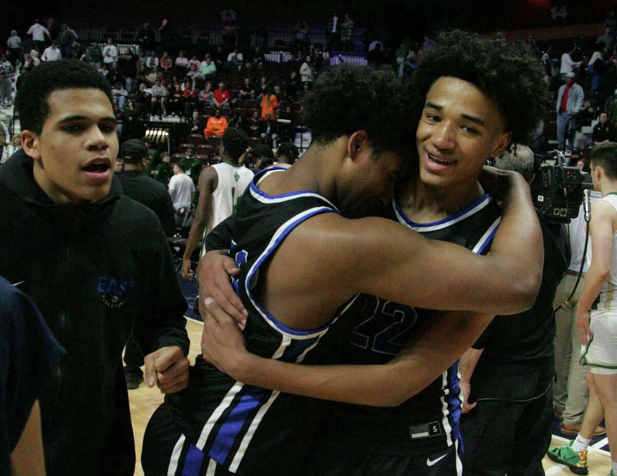 East Catholic's #34 Leondre Sanchez and #22 James Jones celebrate the Eagles 50-49 win over Notre Dame-West Haven during the CIAC 2022 State Boys Basketball Tournament Division I Finals at the Mohegan Sun Arena on March 20, 2022 in Uncasville, Connecticut.