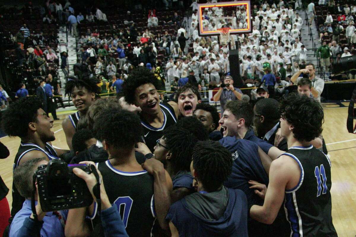 East Catholic celebrates their 50-49 win over Notre Dame-West Haven during the CIAC 2022 State Boys Basketball Tournament Division I Finals at the Mohegan Sun Arena on March 20, 2022 in Uncasville, Connecticut.