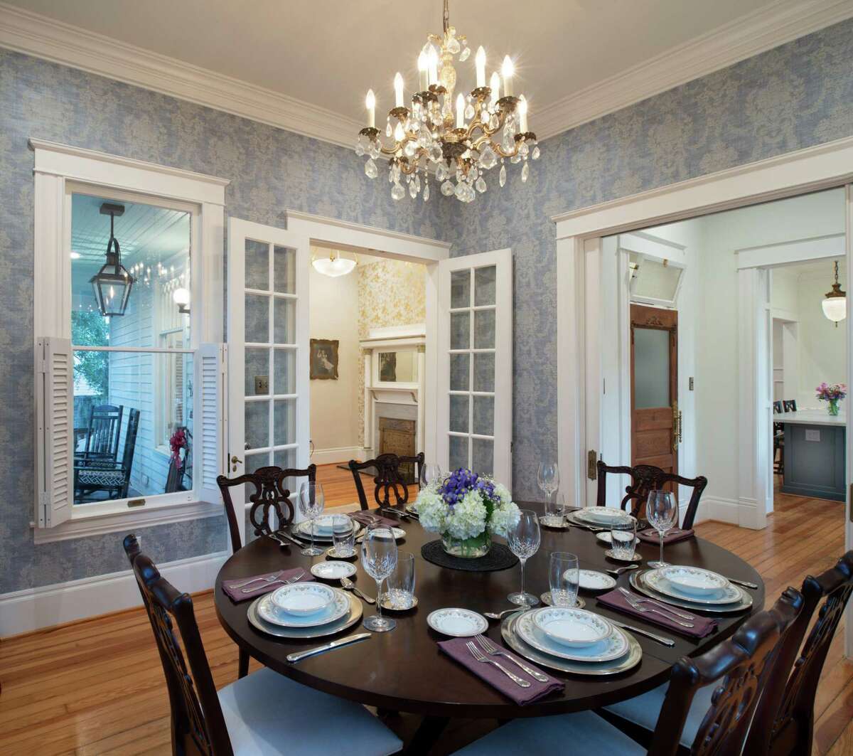 The dining room of the Heckendorns’ home looks out onto a big live oak tree and the street.
