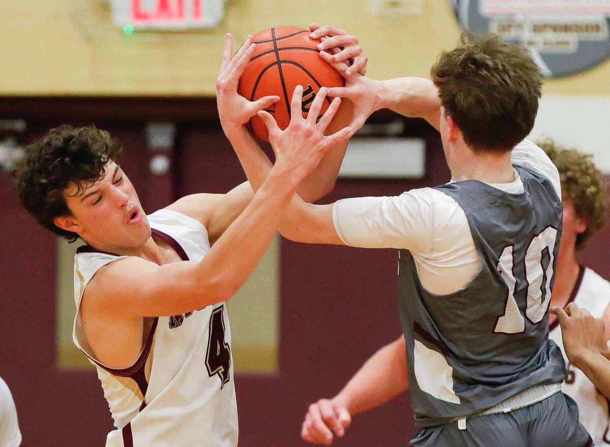 Magnolia West point guard Jacob Homer (4) knocks the ball out of the hands of Magnolia shooting guard Tyler Podhaisky (10) in the second quarter of a high school basketball game at Magnolia West High School, Friday, Feb. 4, 2022, in Magnolia.
