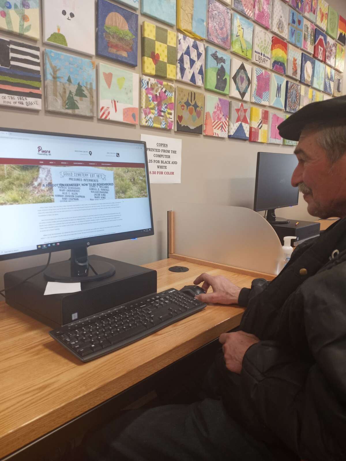 Sid Woods, trustee on the Pinora Township board, as well as the local historian who rediscovered the Gould Cemetery, is checking out the new website for the township.
