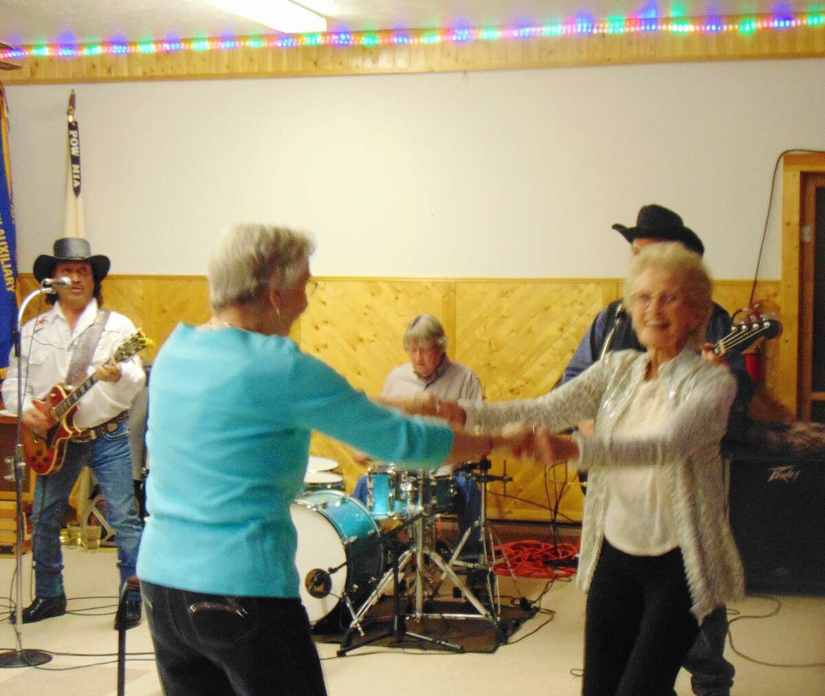 Lee Schwartz, right, enjoyed her favorite activity — dancing — during a retirement party in her honor, with a live band providing country music.