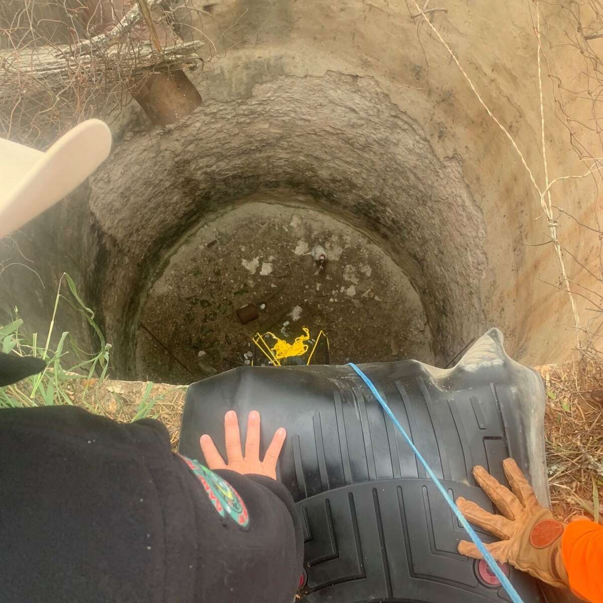 Texas Game Wardens recently rescued a dog trapped in an abandoned grain silo-turned well 50 feet below in Jim Hogg County, which is in South Texas near Laredo.  