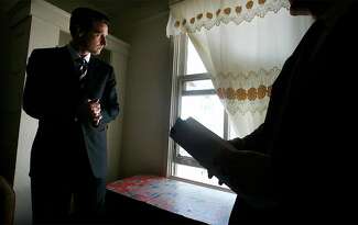 Then-Mayor Gavin Newsom tours a room at the McAllister Hotel in 2004.