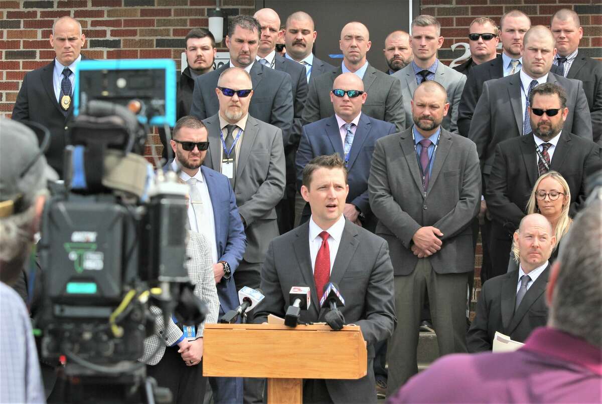 Flanked by investigtors, Madison County State's Attorney Tom Haine speaks Tuesday at the Maryville Police Department during a press conference announcing charges in last week’s murder of a Missouri man on N. Bluff Road. Danyel M. Johnson, 40, of St. Louis, was charged in the shooting death of Ronald L. Holland, 40, of Jennings, Missouri Thursday, March 17 in the 2000 block of N. Bluff Road.