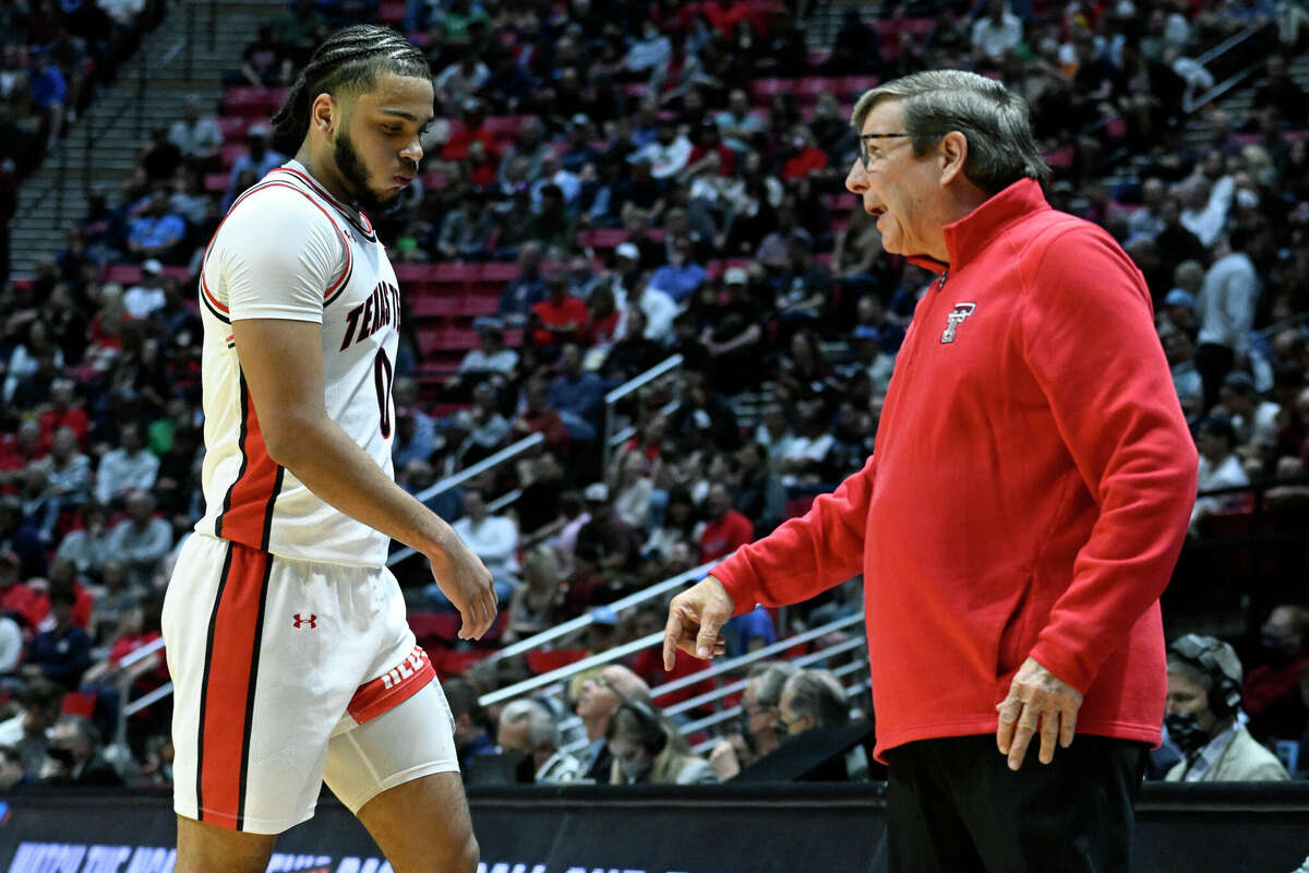 Texas Tech head coach Mark Adams, right, talks with forward Kevin Obanor, left, during the first half of a second-round NCAA college basketball tournament game against Notre Dame, Sunday, March 20, 2022, in San Diego. (AP Photo/Denis Poroy)