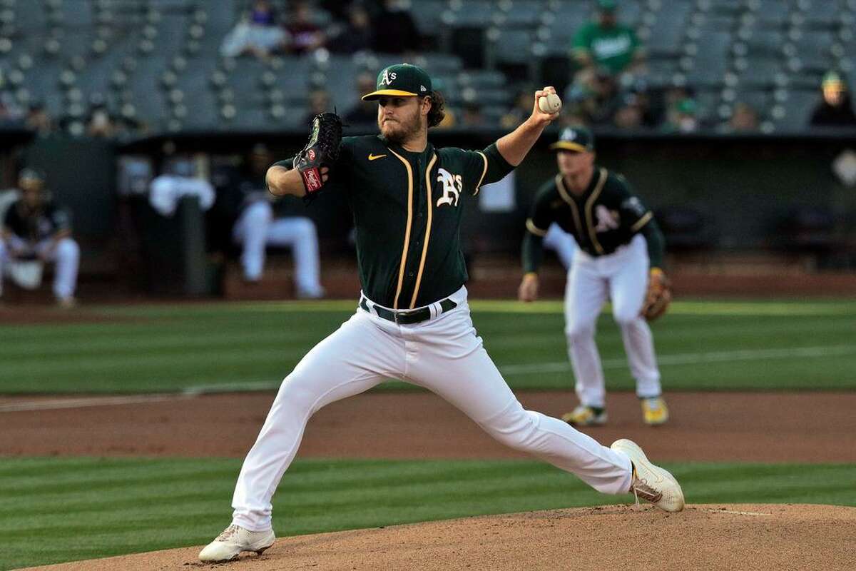 Cole Irvin (19) pitches in the first inning as the Oakland Athletics played the Los Angeles Angels at the Coliseum in Oakland, Calif., on Monday, July 19, 2021.