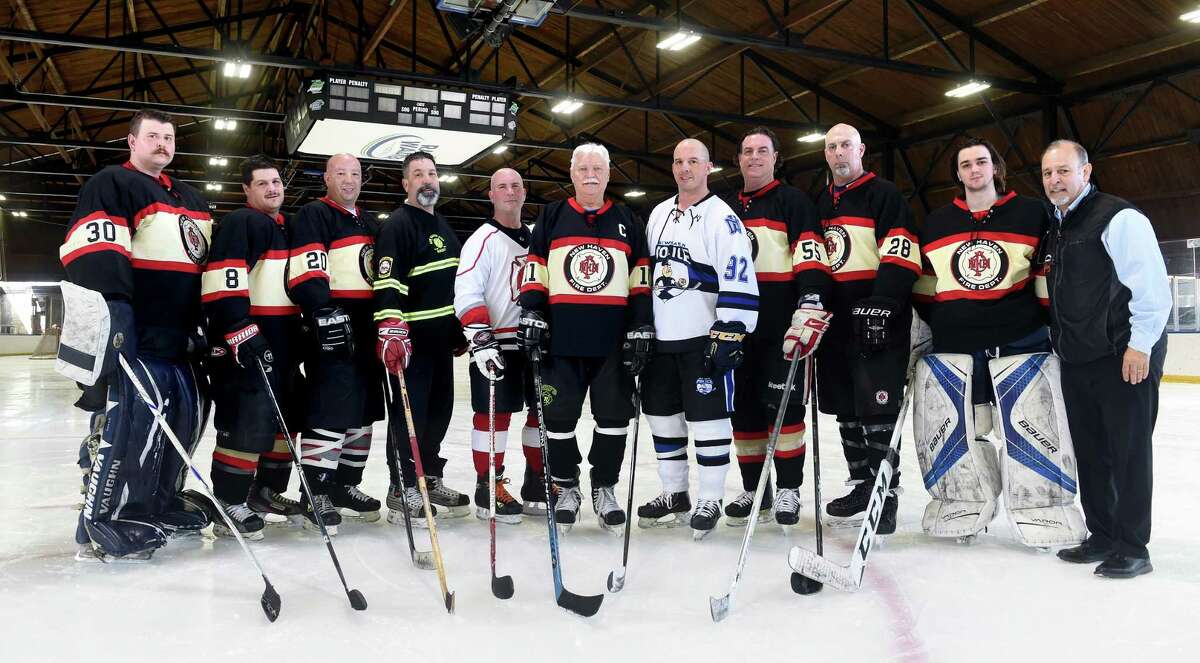 Some of the New Haven Fire Department and New Haven Police Department participants for the 25th annual Elm City Cup and Chiefs Cup hockey games, after a practice at Ralph Walker Rink in New Haven Monday.