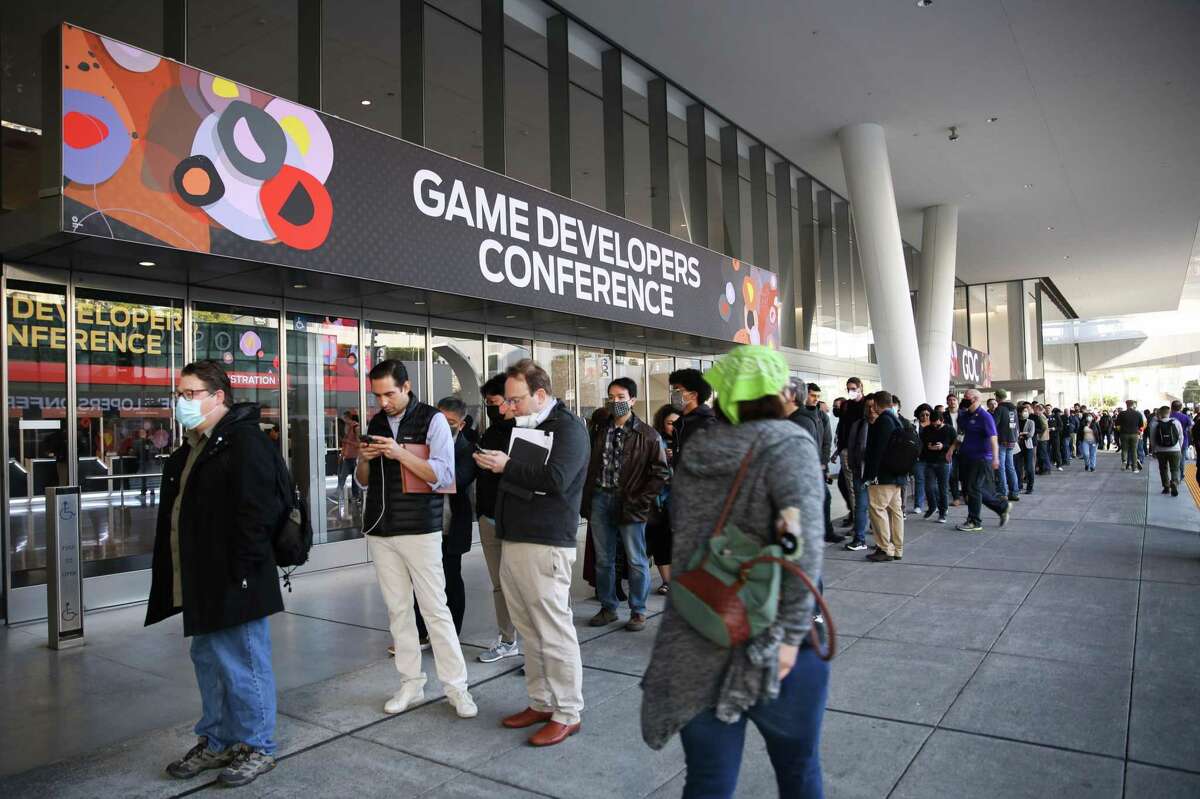 People wait in line to confirm their vaccination at the Game Developers Conference on Monday in San Francisco. Organizers of the conference said more than 12,000 hotels were booked for the event.