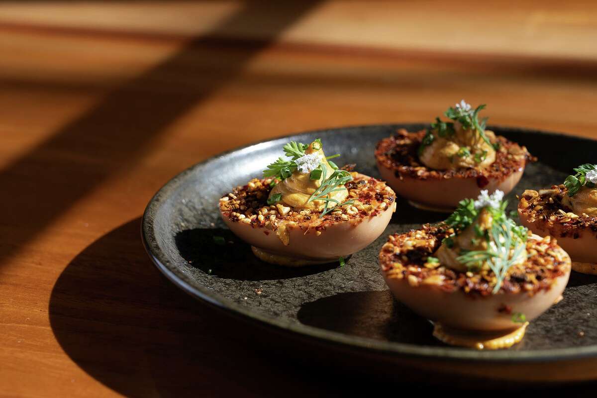 Terra cotta deviled eggs topped with dried salsa macha and herbs at El Alto in Los Altos.