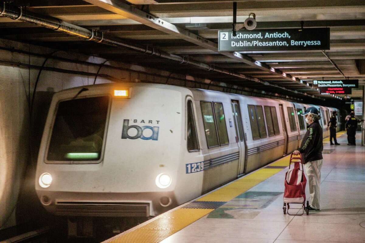 A rider is seen waiting for a BART train.