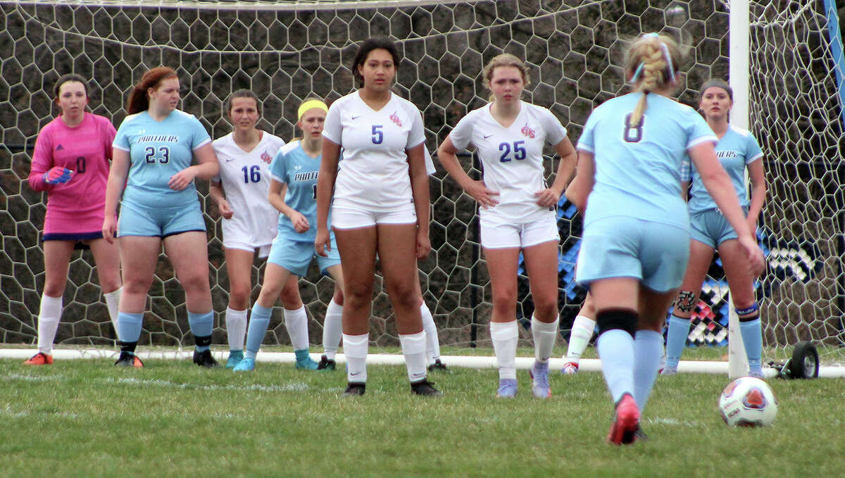 Jersey's Kaelyn Drainer (8) attempts a free kick as Carlinville defenders watch Monday at Jersey. 