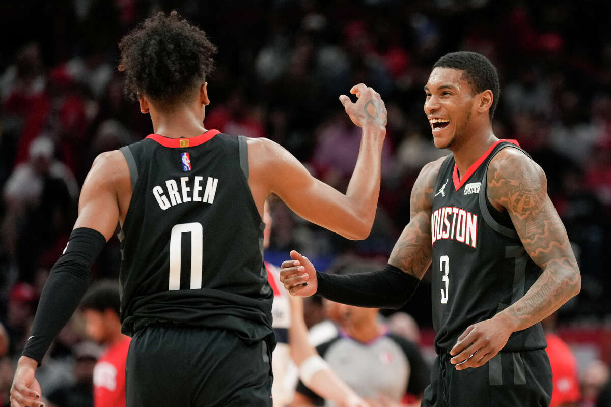 Houston Rockets guard Kevin Porter Jr. (3) reacts after guard Jalen Green's (0) 3-point basket to end the first half of an NBA basketball game against the Washington Wizards, Monday, March 21, 2022, in Houston. (AP Photo/Eric Christian Smith)