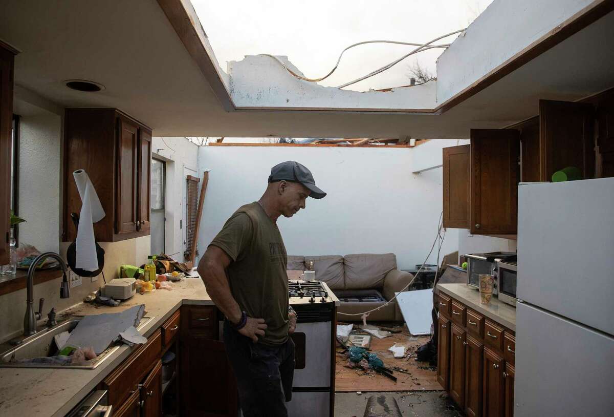 Michael Talamantez looks at his house on Stratford Drive in Round Rock, Texas, after it was destroyed by a tornado while he was inside on Monday March 21, 2022. "I thought I was going to die," he said. (Jay Janner/Austin American-Statesman via AP)