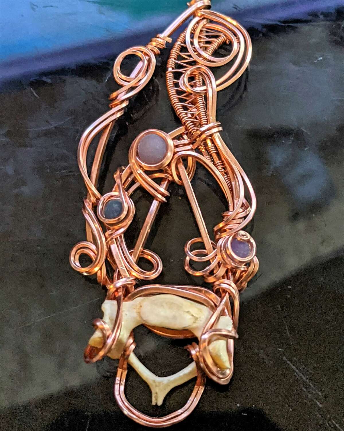 A hand-wire-wrapped pendant by Glamtrashzodiac, founded by CyRen Sohngs in 2015. The Alton-based jewelry maker will be a popup shop at Kooliverse Couture Night 3, at 6 p.m., Thursday, at The Conservatory, 554 E. Broadway, in Alton. 