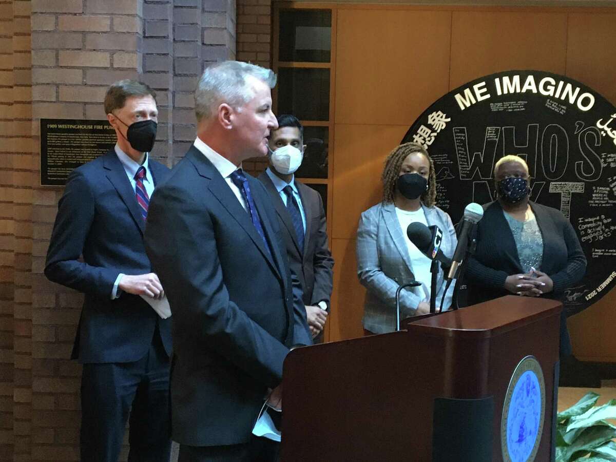 Kevin Stratton, New Haven's new director of public safety communications, speaks at a press conference in City Hall March 21, 2022. To his left, (light-colored blazer) is Tomi Veale, new acting director of the Department of Elderly Services.